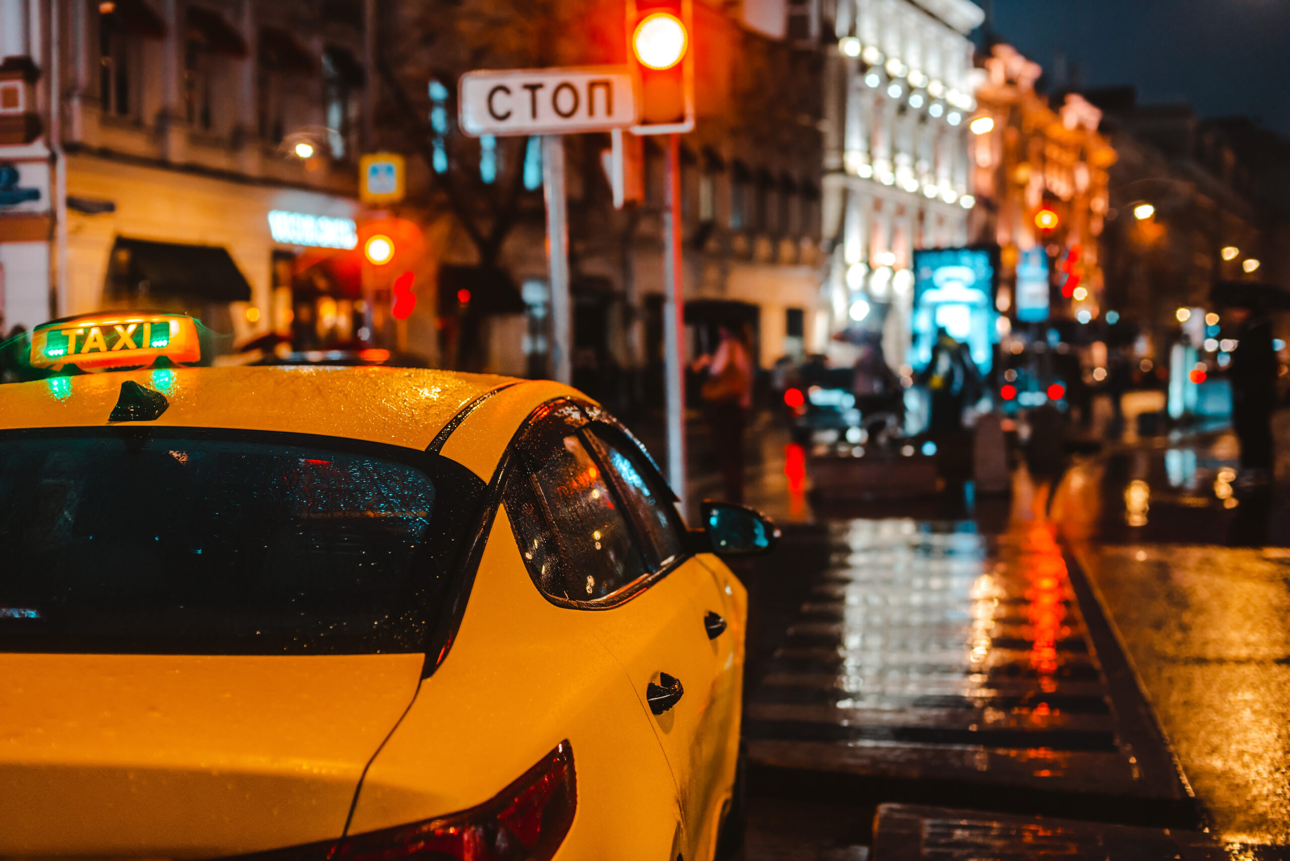 Wet night city street rain Bokeh reflection bright colorful lights puddles sidewalk Car headlights lighting reflection wet asphalt road. traffic congestion, rush hour, taxi, transport, yellow